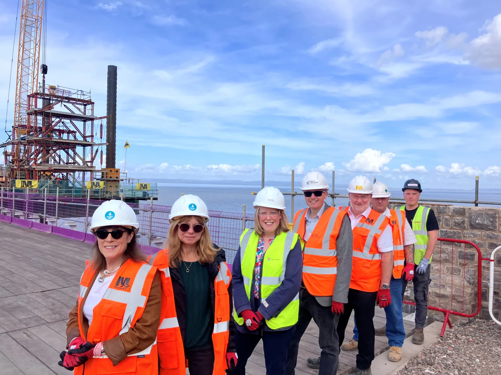 Funders, contractors and council representatives on Birnbeck Pier's replacement deck on Monday 28 September, with the jack-up barge and crane behind them.
