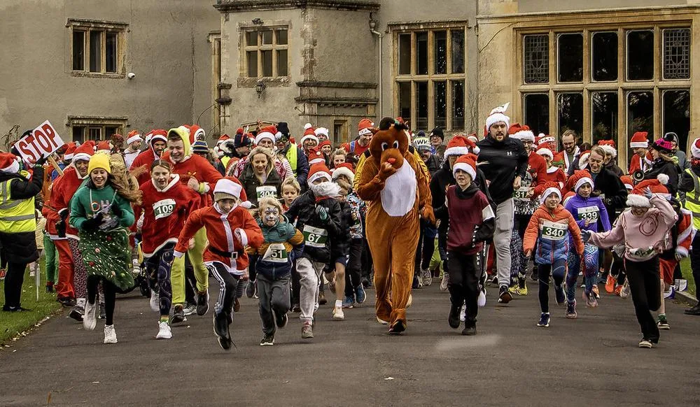Runners in Santa hats and fancy dress set off from the start of Santas on the Run North Somerset